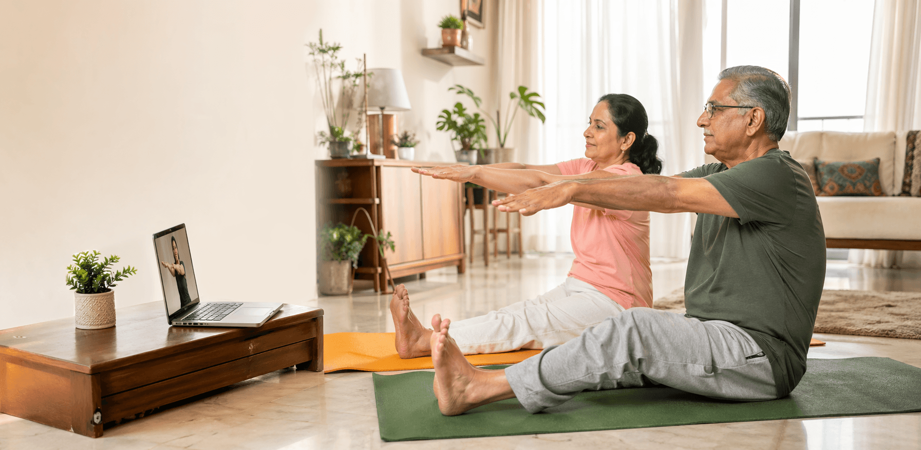 Indian parents doing gentle guided online wellness class from home